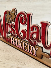 Load image into Gallery viewer, Mrs. Claus' Bakery Shelf Sitter Christmas Standing Sign File SVG, Santa Gingerbread Mantle decor Centerpiece glowforge LuckyHeartDesignsCo